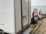two white vans parked next to each other on the side of the road