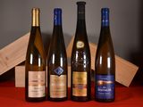 three bottles of wine are lined up on a table