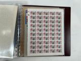a picture of a binder with a sheet of stamps on it