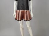 a mannequin mannequine wearing a black and copper dress