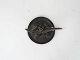 a metal object with a bird on it on a white surface