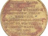 an old coin with writing on it sitting on a white surface