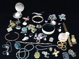 many different types of jewelry on a black table