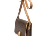 a brown and tan handbag with a brown strap