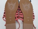 a pair of pink sandals on a white surface