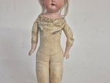 a small doll that is standing on a table