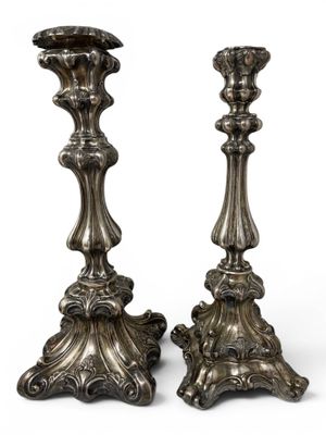 pair of antique silver candlesticks on a white background