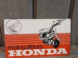 a sign that says motor cutters honda on the side of a building