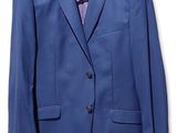 a close up of a suit on a hanger on a white wall