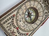 a compass in the middle of a book on a table