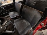 a red car with black leather seats and a steering wheel