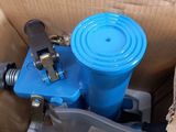 a blue water pump in a cardboard box with a blue lid