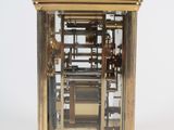 a gold clock that is sitting on top of a table