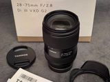 a box with a camera lens and a lens cap on it