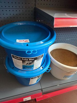 two buckets of coffee on a shelf in a store