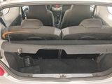 two seats in the back of a car with luggage in the trunk