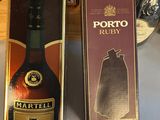 two boxes of liquor sitting on top of a table next to a bottle of wine