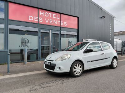une petite voiture blanche garée devant un hôtel