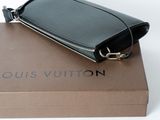 a black purse sitting on top of a brown box