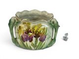a vase with a flower on it next to a small bird