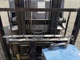 a forklift with a blue box on the back of it