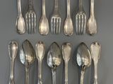 a lot of silver spoons and forks on the table
