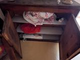 a small desk with a drawer and a lamp on it