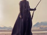 a woman that is standing on a rock with a sword