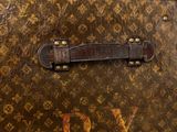 a close up of an old suitcase with a leather handle