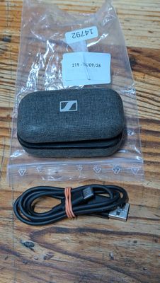 a black case and a charger on a wooden table