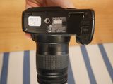a person holding a camera in their hand on a table