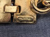 a close up of a gold metal key on a blue cloth