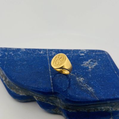 yellow gold signet ring on a lapel of lapel of lapel of lapel of lapel of lapel of lapel of lapel of lap
