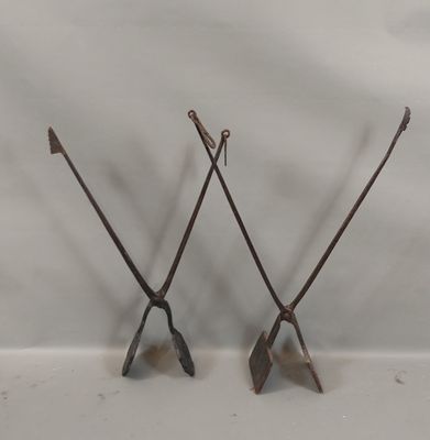 pair of antique iron garden tools on a white background
