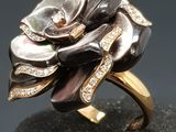 an image of a black and white flower ring on a black surface