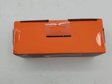 a close up of an orange box on a white surface