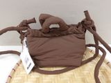 a brown bag with a brown handle on a table