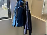a coat rack in the corner of a room next to a window