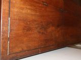 a wooden cabinet with a door on top of it