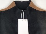 a close up of a black sweater with a tag on it