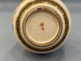 a close up of a vase on a table