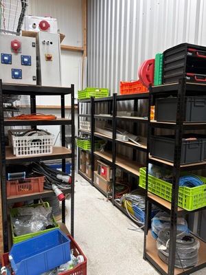 a room with a lot of boxes and crates on the shelves