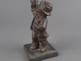figurine of a boy with a hat on his head