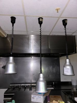 three lights hanging from the ceiling in a kitchen