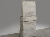 an image of a sculpture of a stack of books on a concrete floor