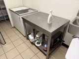 a kitchen with a sink and a washer in it
