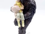a figurine of a man holding a child in his arms
