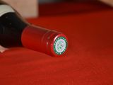 a bottle of wine sitting on a red table