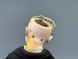 a small doll with a broken head on top of a table