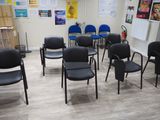 many chairs in a room with posters on the wall